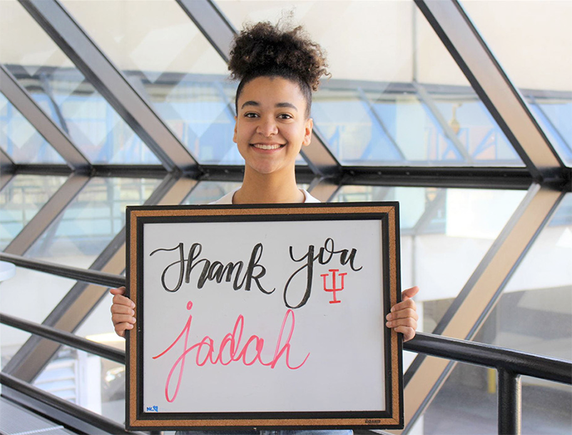 Student holding sign that says Thank you jadah