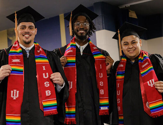 Three Hispanic students at IU South Bend graduation.