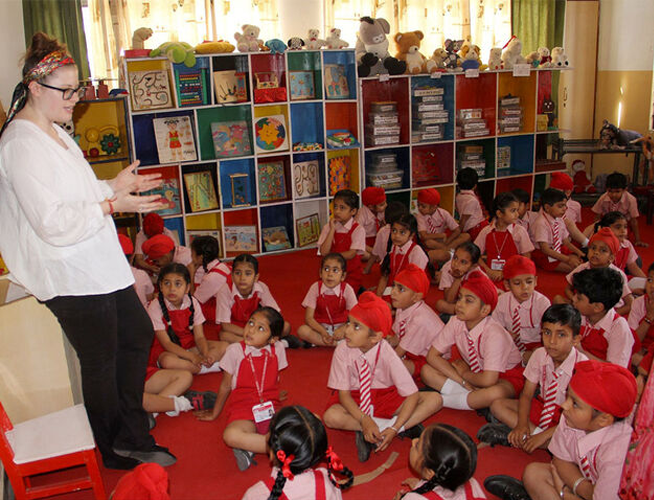 A student teacher teaching a group of young students.