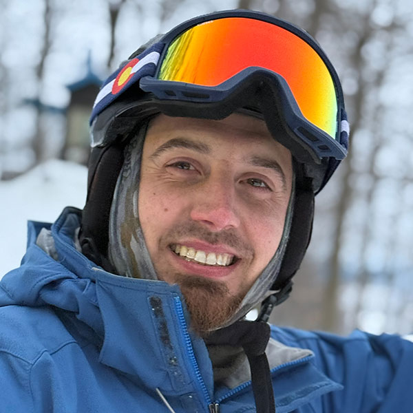 A headshot of Tyler Kanczuzewski, dressed in ski gear.