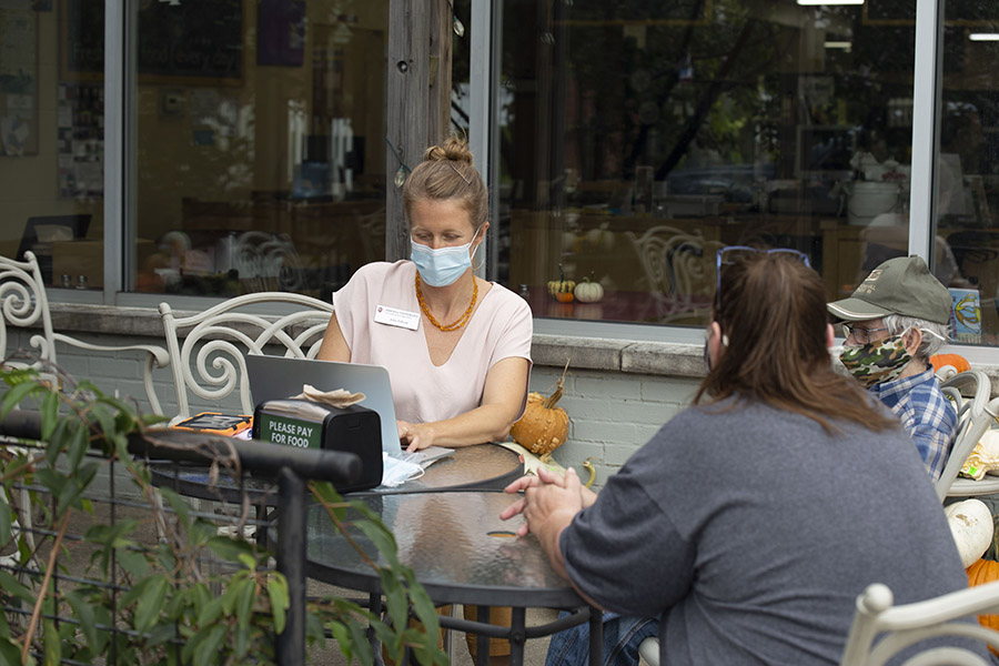 Students working outside on a laptop.