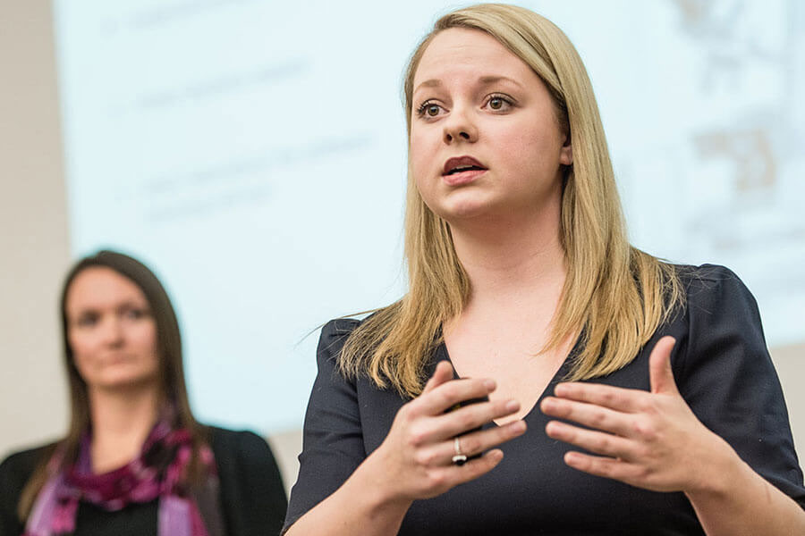 Two female students give a class presentation.