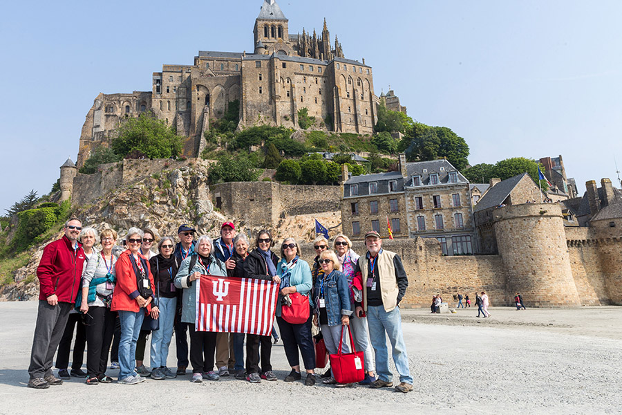 A group standing outside of a European castle.