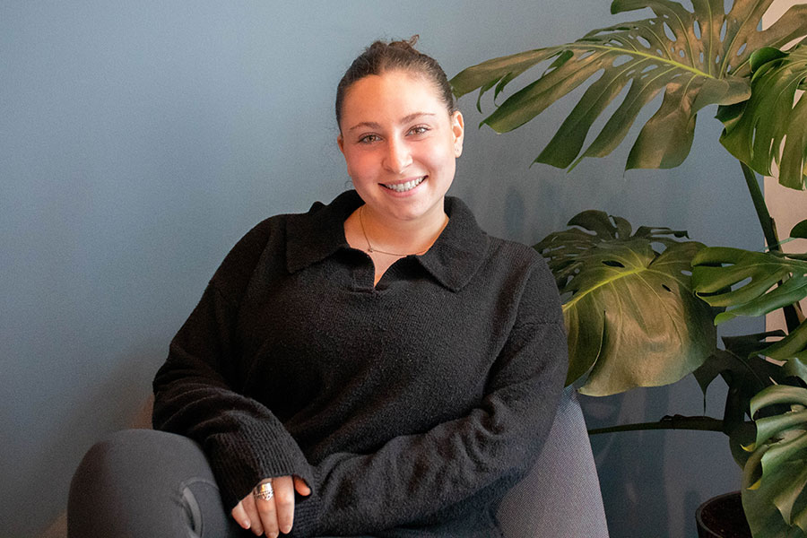 Scholar recipient, Julia Orel sits in a chair.