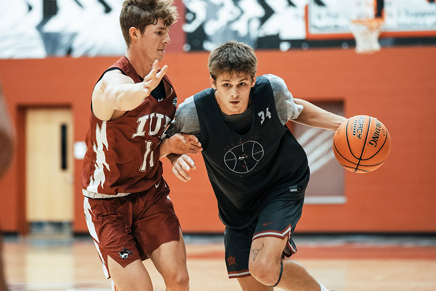 An action shot of a male basketball player.