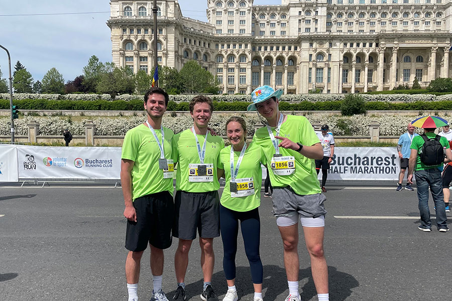 A group of students poses with medals as they finish the Bucharest Half Marathon.