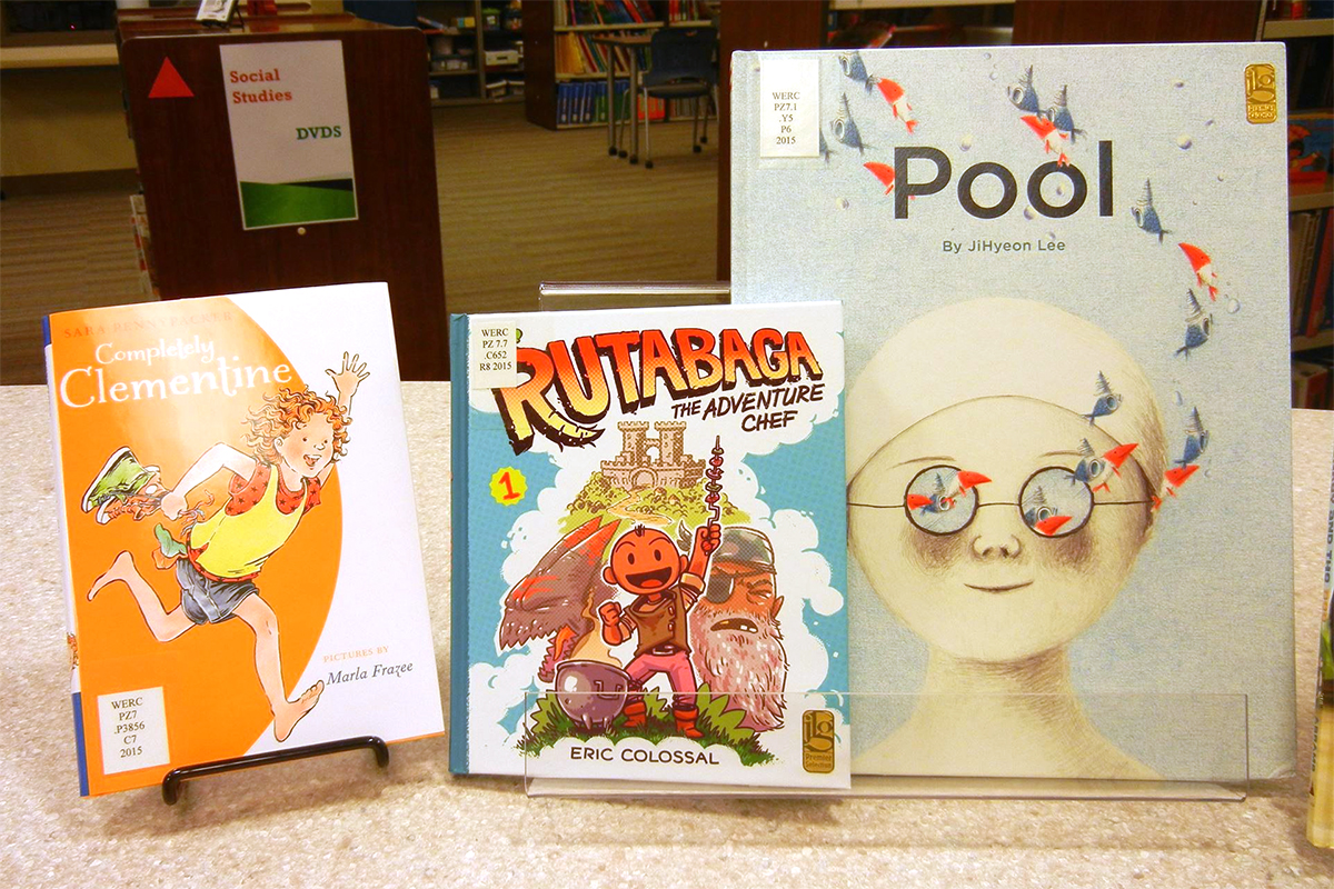 Three children's books on display at the library: Completely Clementine by Sara Pennypacker; Rutabaga the Adventure Chef by Eric Colossal; and Pool by JiHyeon Lee.