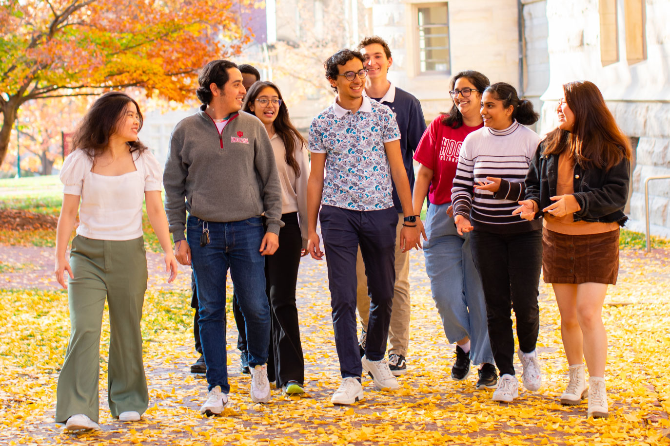 A big group of international students walking on the IU Bloomington campus on a beautiful autumn day.