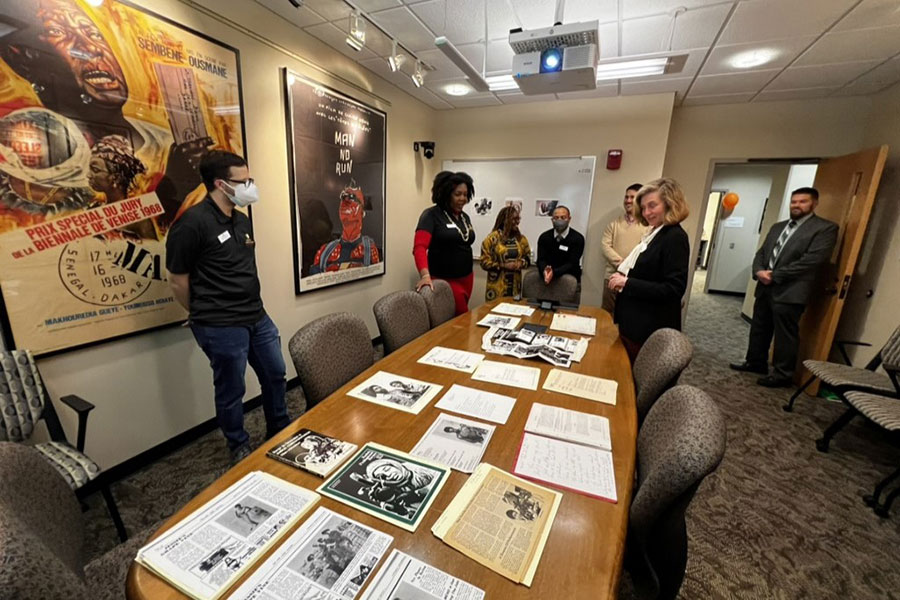 President Whitten overlooks items from the Black Film Center and Archive in a conference room.