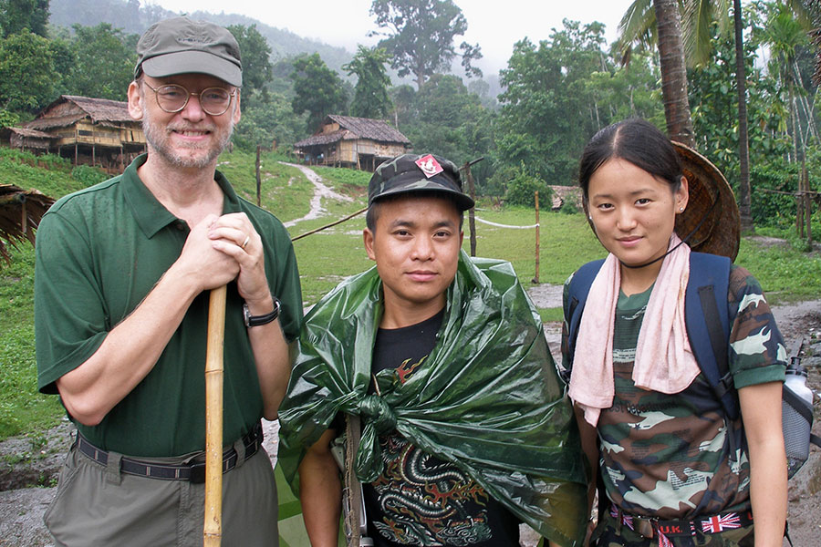 Professor David Williams stands with two people in Vietnam.