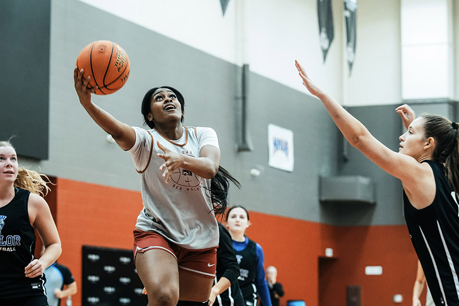 An action shot of a female basketball player.