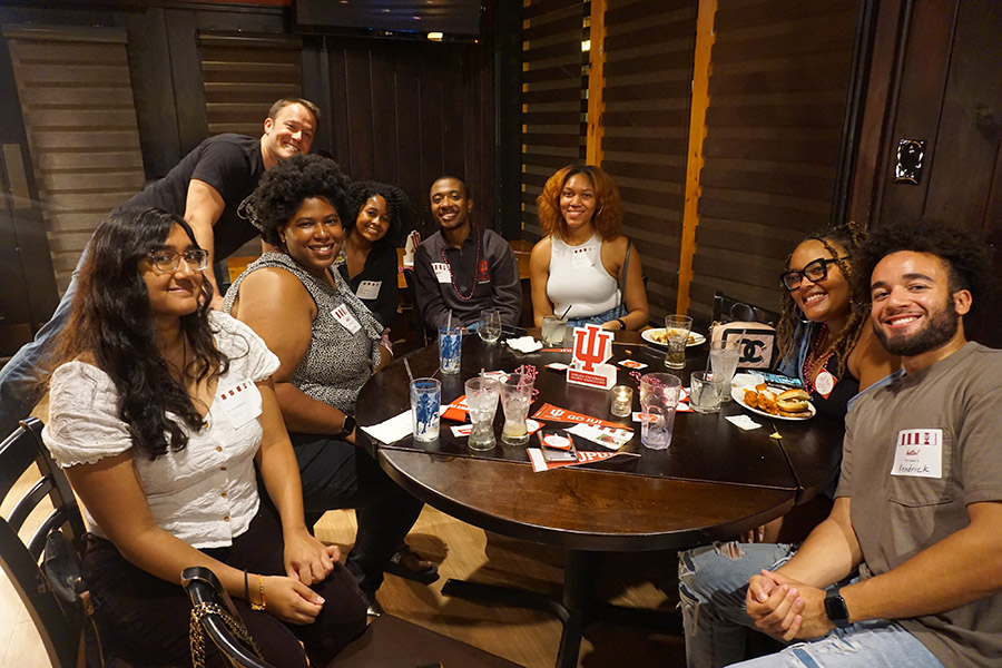 A group of IU alumni meet at a restaurant in Chicago.