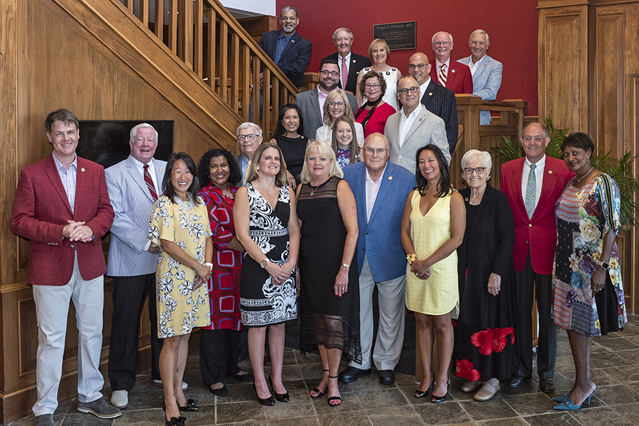 Alumni Association members pose together at the Alumni Center.