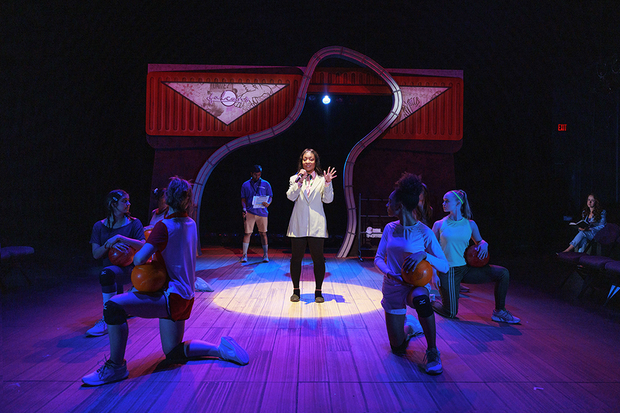 A group of theatre students on stage during a production.