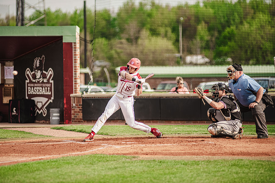 An IU Southeast baseball player swings at home plate.